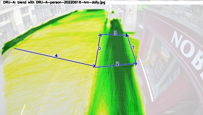 One of four images from cameras positioned above the junction. The first shows only the background image. The second has red lines superimposed indicating the paths of cars. The third has blue lines superimposed showing the paths of cyclists. The fourth has green and yellow lines superimposed showing the paths of pedestrians.