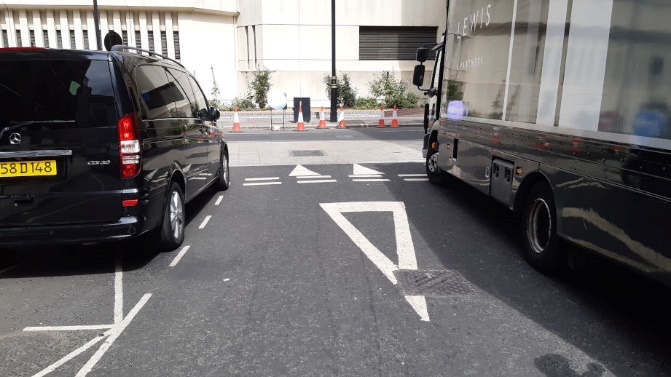 Image shows high car and large lorry blocking visibility of crossing pedestrians.
