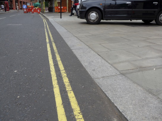 Photo showing transition between main road carriageway and drivable space is flush.