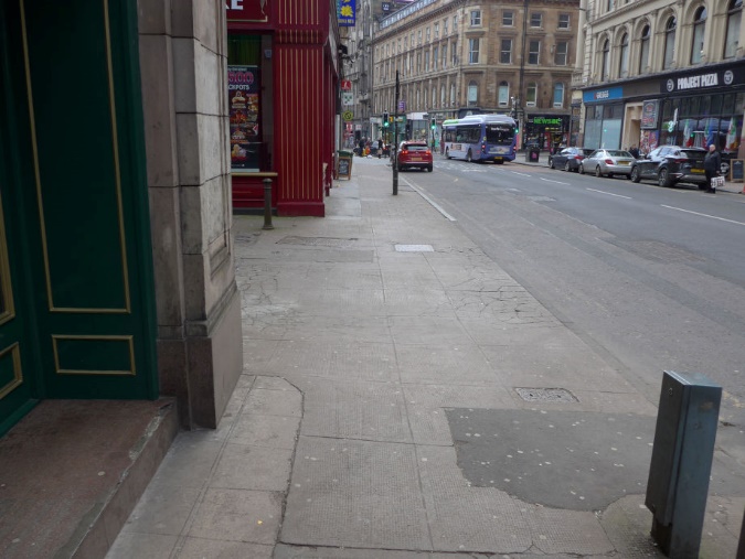 The entrance to Drury Street from Renfield Street. The footway continues across this, but at carriageway level. The footway and carriageway have a similar colour.