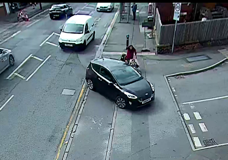 The first of four images from the fixed camera at Haddon Road. The car is still only halfway through making the turn into Haddon Road, but it is now entirely blocking the path of the pedestians. 
